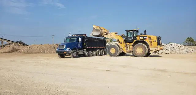 Blue Wright Materials Dump Truck Being filled with construction stone
